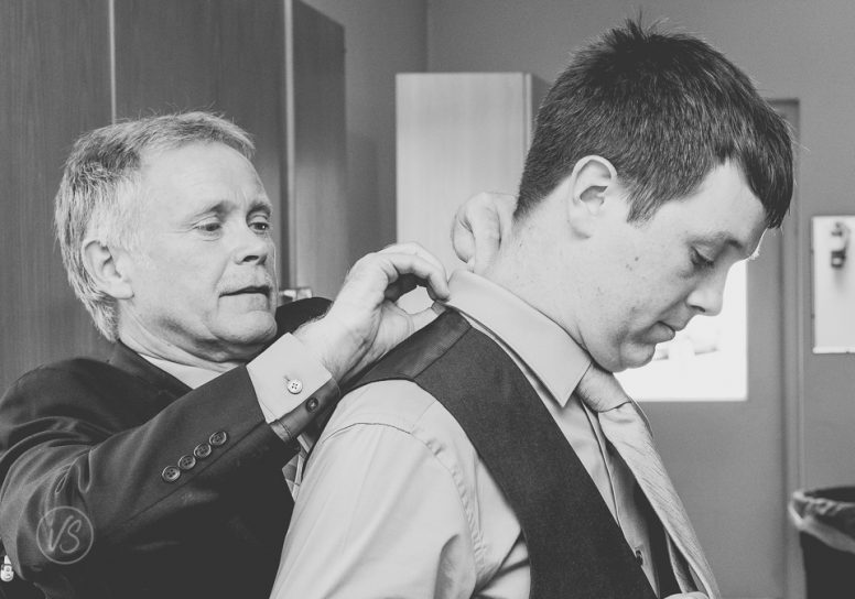 Dad helping groom get ready
