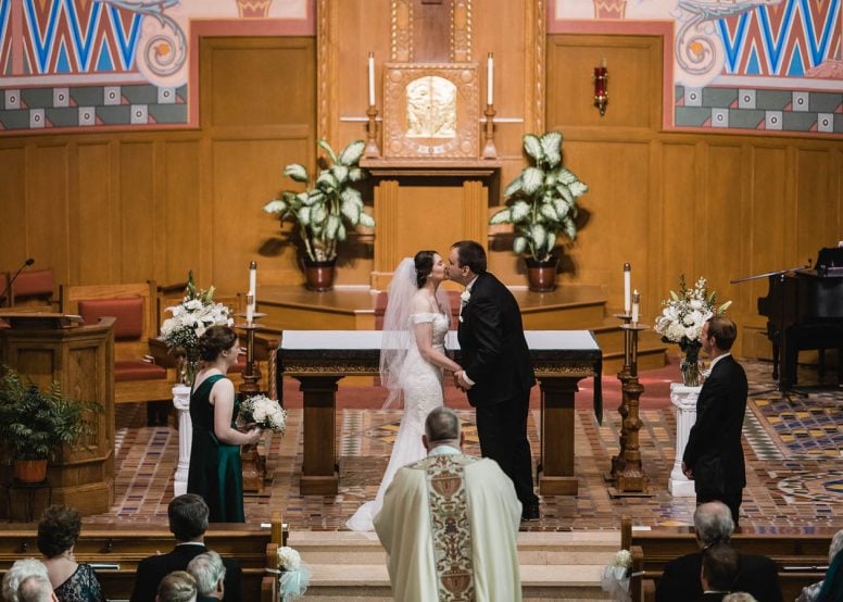 Bride and groom kissing at wedding ceremony