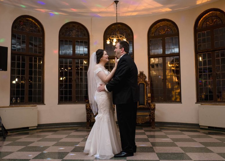 Bride and groom laughing and dancing at wedding reception