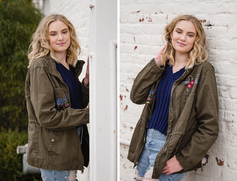 beautiful teen girl leaning against brick wall